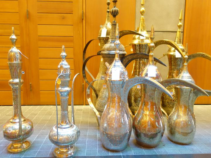 A dallah pot of Arabic coffee with small cups